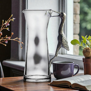 The Egret Carafe/Pitcher in use at a dinner table, illustrating how this unique glass carafe elevates home entertaining with style.