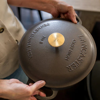 Lancaster 5 Quart Dutch Oven Cast Iron with Brass Knob showcasing its smooth pre-seasoned interior surface for easy cooking.