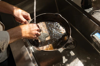 Lancaster 5 Quart Dutch Oven Cast Iron with Brass Knob placed on a rustic kitchen counter, emphasizing American craftsmanship.